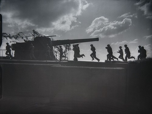Royal Artillery gun crews rush to take post at their 9.2in guns during a practice shoot at — related to explosives